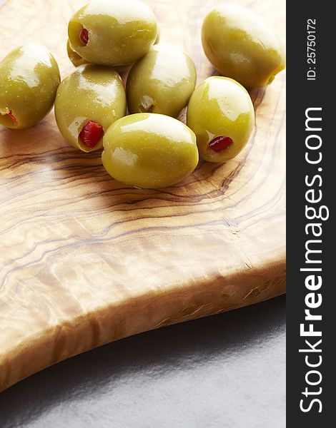 Green olives on olive wood platter