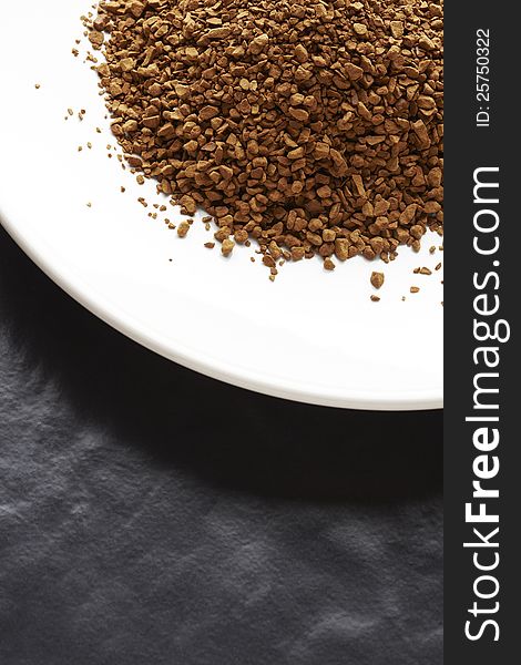 Instant coffee granules on white plate