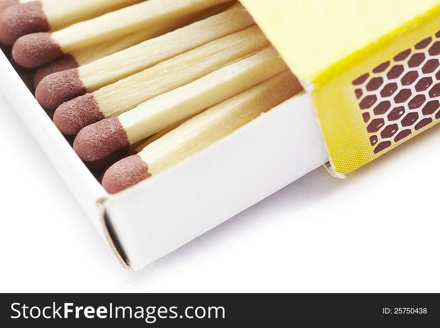 Matches in a yellow match box on white background. Matches in a yellow match box on white background