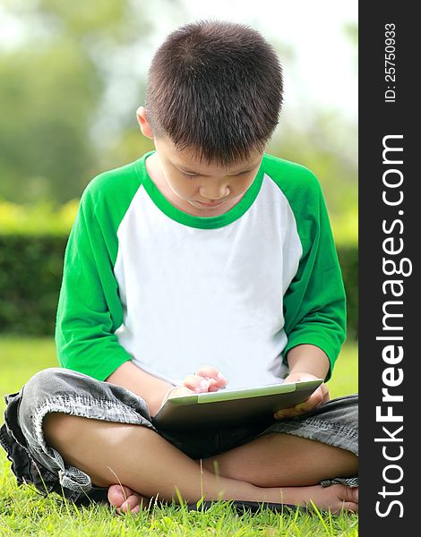 Boy using digital tablet, Outdoor, weekend