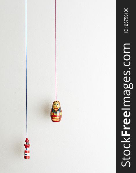 Designer light switch pull cords of Russian doll and lighthouse