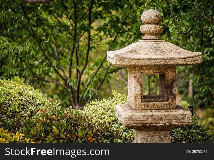 A Japanese Lantern in a botanical garden setting. A Japanese Lantern in a botanical garden setting.