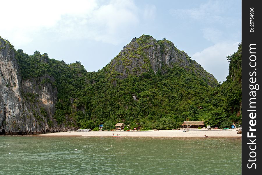 Beautiful and quiet beach with forest and limestone cliffs around in Vietnam.