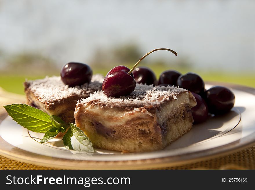Chocolate and pudding cake, sliced and topped with cherries. Chocolate and pudding cake, sliced and topped with cherries
