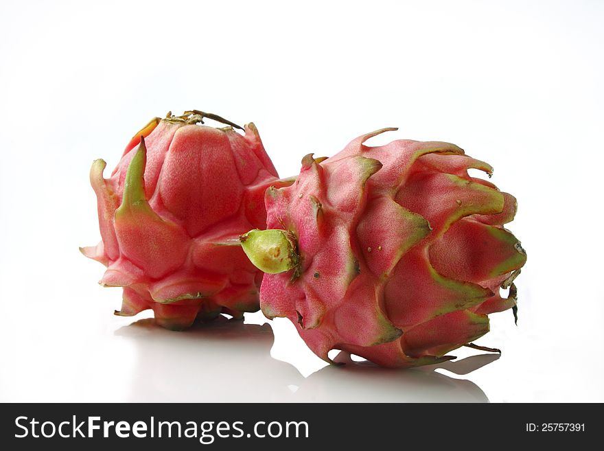 Vivid and vibrant red dragon fruit isolated on white. Vivid and vibrant red dragon fruit isolated on white