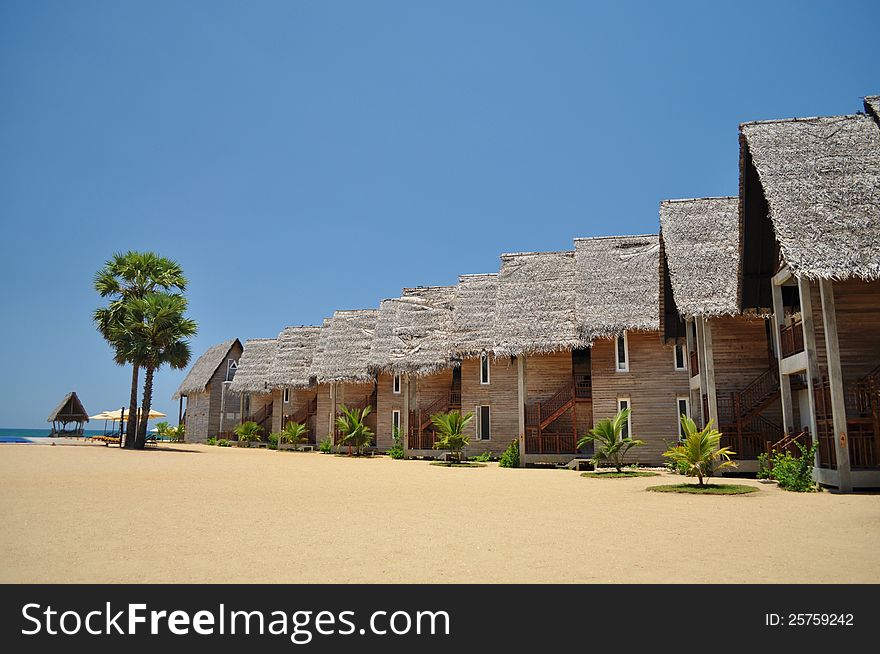 Chalet accomodation on a beach at a tropical resort. Chalet accomodation on a beach at a tropical resort