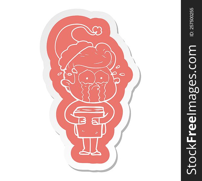 cartoon  sticker of a crying man holding book wearing santa hat