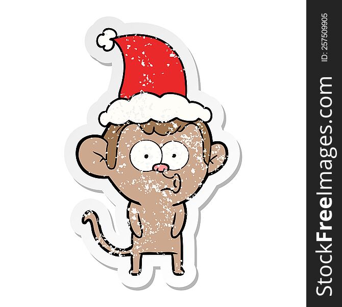 hand drawn distressed sticker cartoon of a hooting monkey wearing santa hat