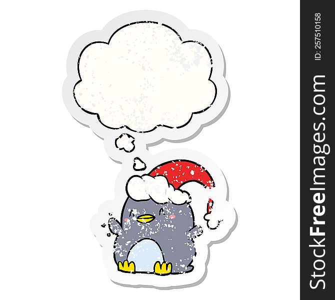 Cartoon Penguin Wearing Christmas Hat And Thought Bubble As A Distressed Worn Sticker