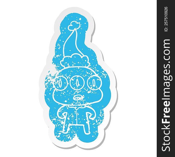 quirky cartoon distressed sticker of a three eyed alien wearing santa hat