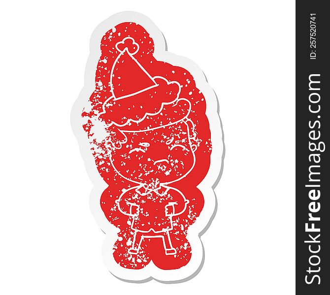 quirky cartoon distressed sticker of a annoyed man wearing santa hat