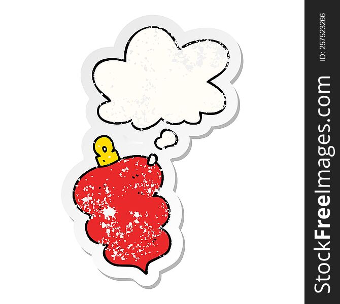 cartoon christmas bauble with thought bubble as a distressed worn sticker
