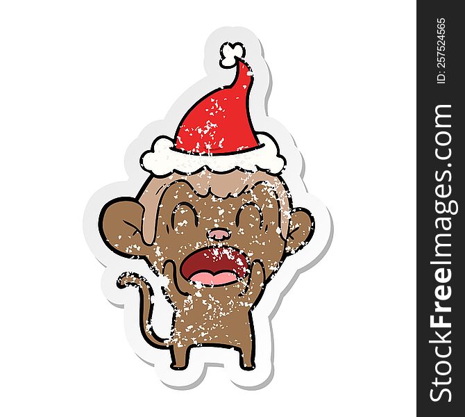 shouting hand drawn distressed sticker cartoon of a monkey wearing santa hat