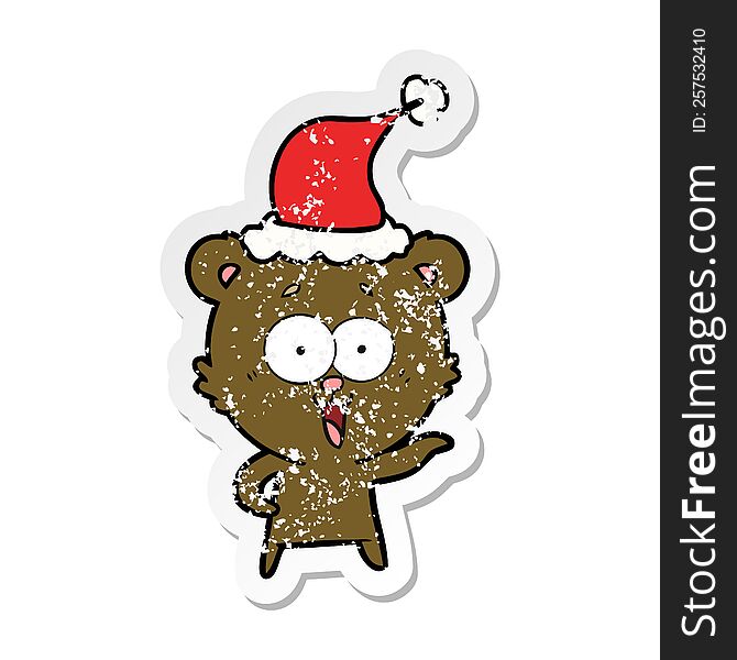 laughing teddy  bear hand drawn distressed sticker cartoon of a wearing santa hat