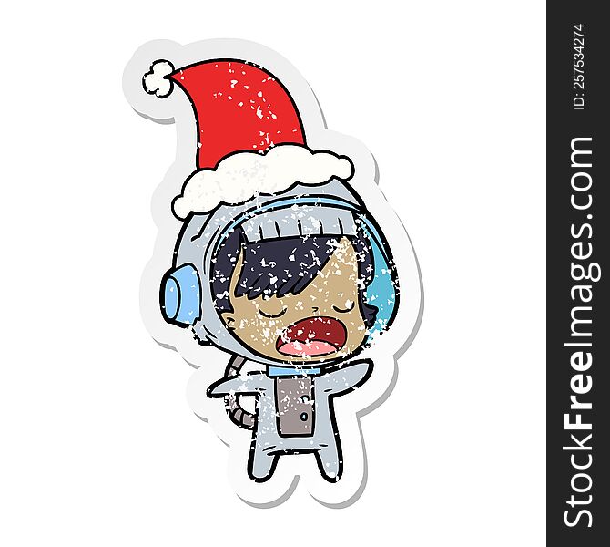 Distressed Sticker Cartoon Of A Talking Astronaut Woman Wearing Santa Hat