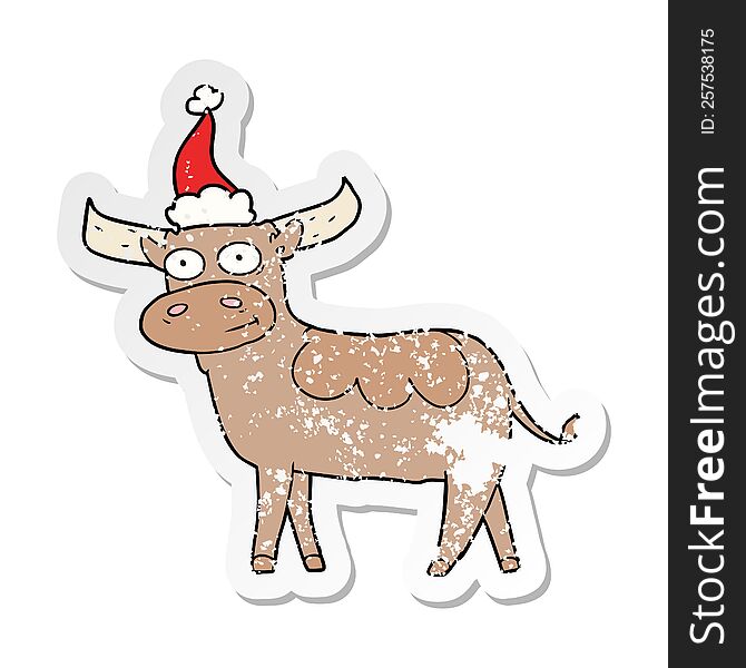 hand drawn distressed sticker cartoon of a bull wearing santa hat