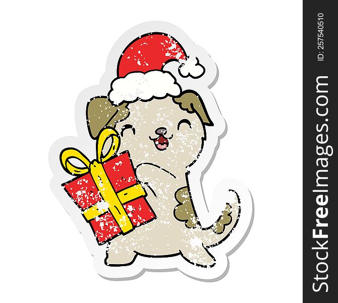 distressed sticker of a cute cartoon puppy with christmas present and hat