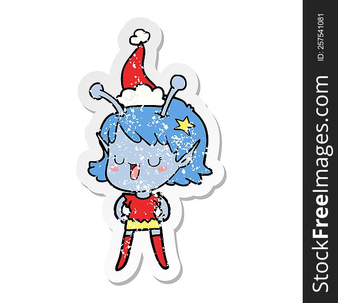 happy alien girl hand drawn distressed sticker cartoon of a wearing santa hat