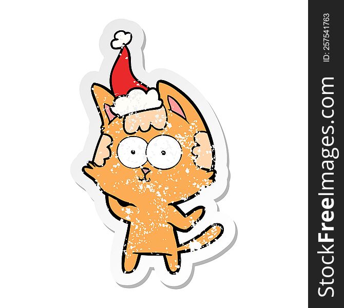 Happy Distressed Sticker Cartoon Of A Cat Wearing Santa Hat