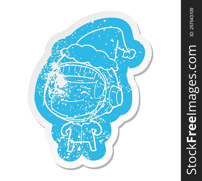 Happy Cartoon Distressed Sticker Of A Astronaut Wearing Santa Hat