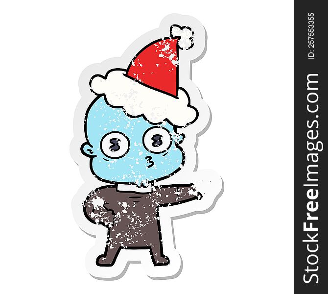 Distressed Sticker Cartoon Of A Weird Bald Spaceman Wearing Santa Hat