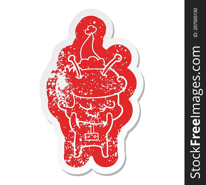 shy quirky cartoon distressed sticker of a spaceman wearing santa hat