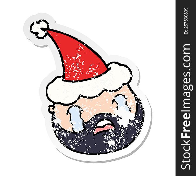 hand drawn distressed sticker cartoon of a male face with beard wearing santa hat