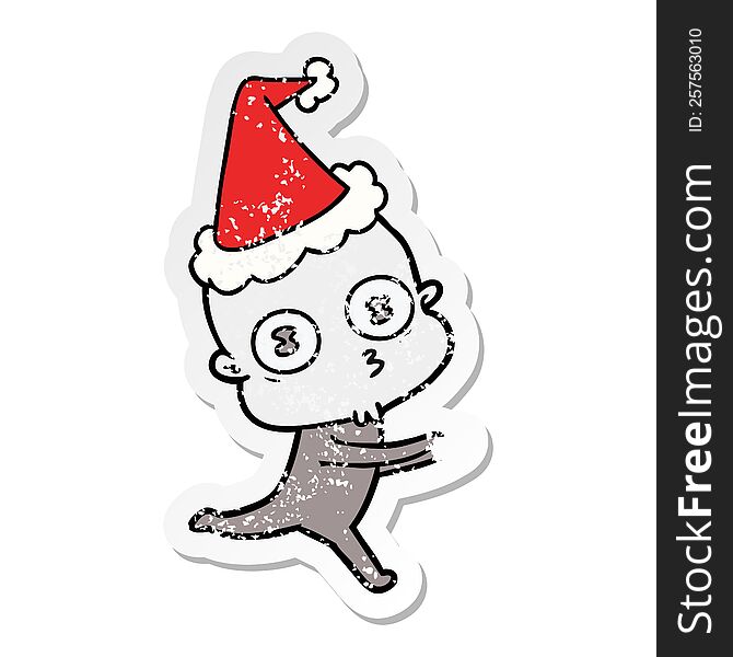hand drawn distressed sticker cartoon of a weird bald spaceman running wearing santa hat