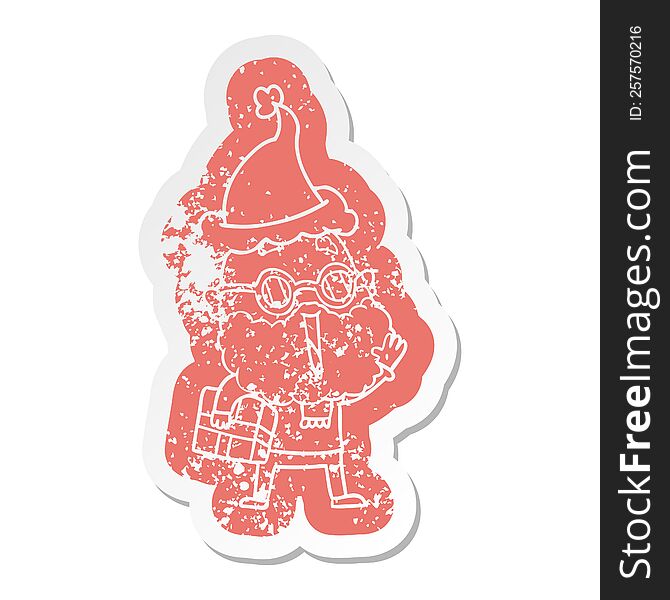 cartoon distressed sticker of a joyful man with beard and parcel under arm wearing santa hat