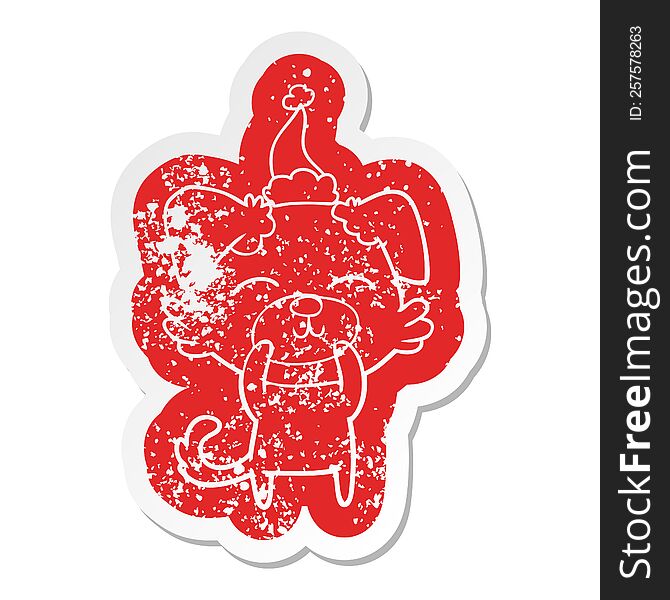 quirky cartoon distressed sticker of a dog wearing santa hat