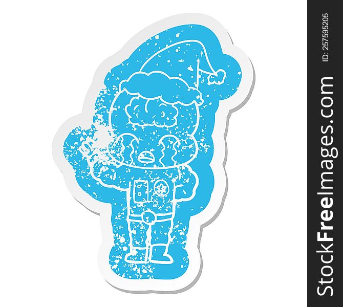 Cartoon Distressed Sticker Of A Big Brain Alien Crying Wearing Santa Hat