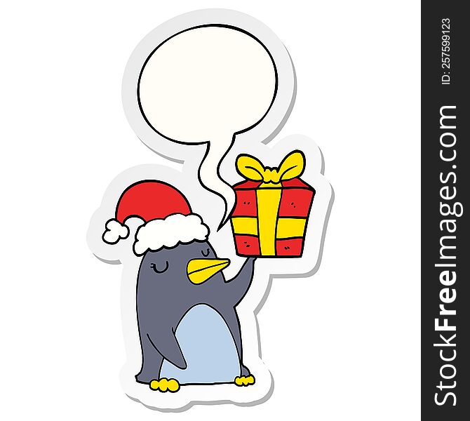 cartoon penguin with christmas present with speech bubble sticker. cartoon penguin with christmas present with speech bubble sticker