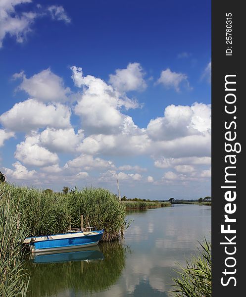 A little blue boat in a lagoon seascape. A little blue boat in a lagoon seascape