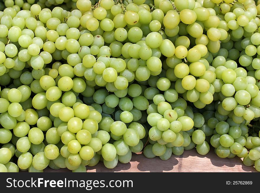 Bunches of white grapes as an agricultural background