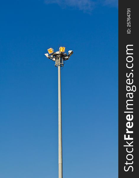 Illuminated lamp post for motor way in blue sky