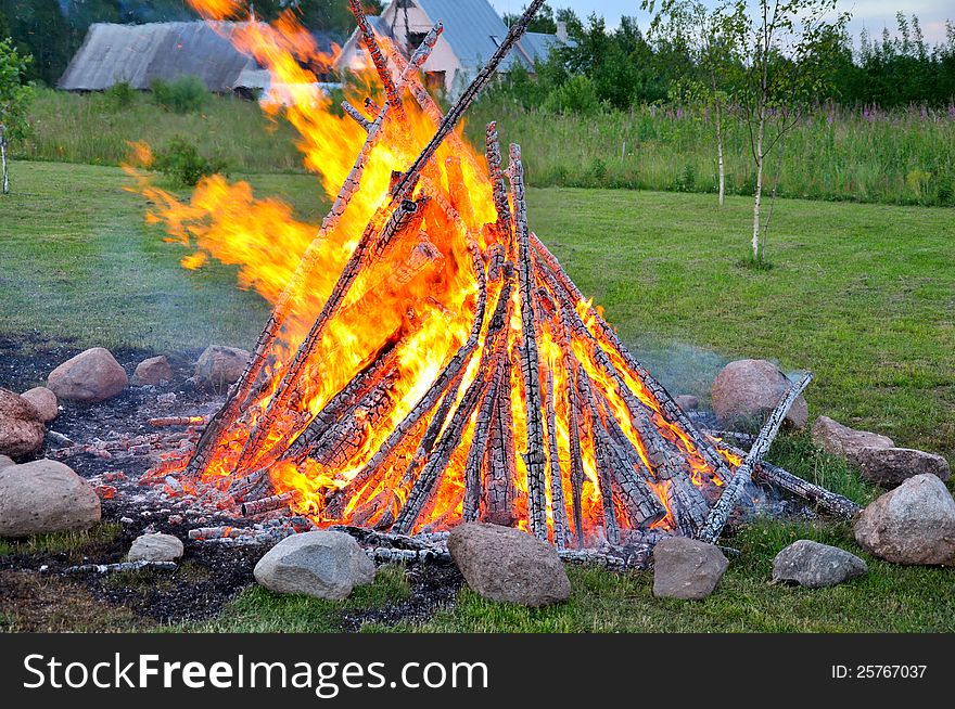 Landscape with bonfire and river