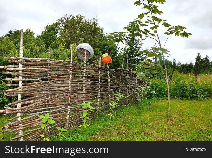 Beautiful countryside with old fence and crocks