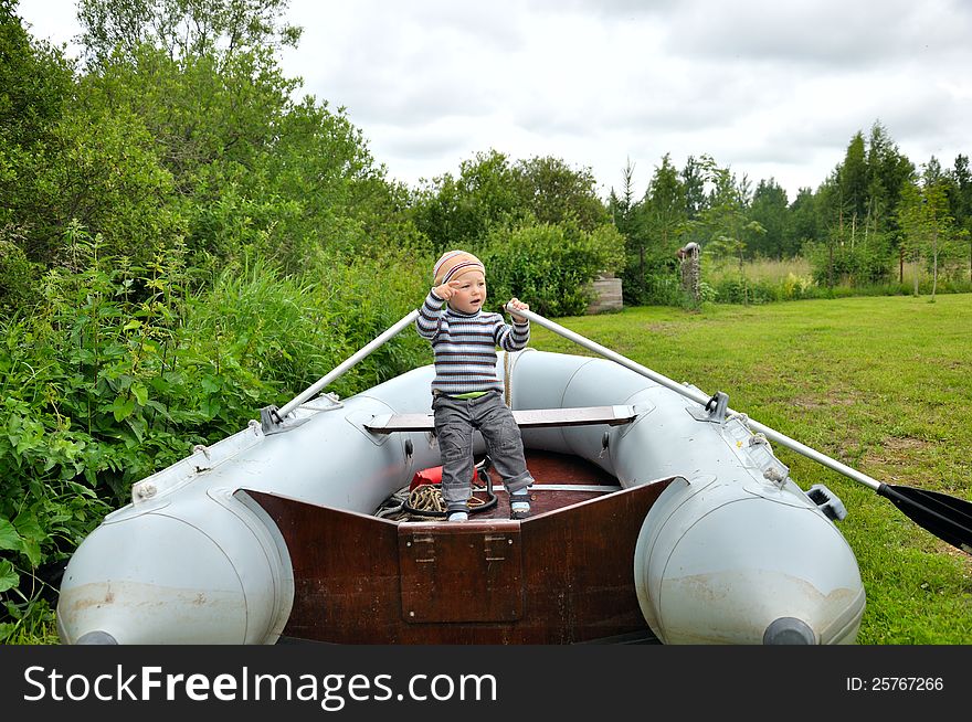 Young boy rowing a boat. Young boy rowing a boat