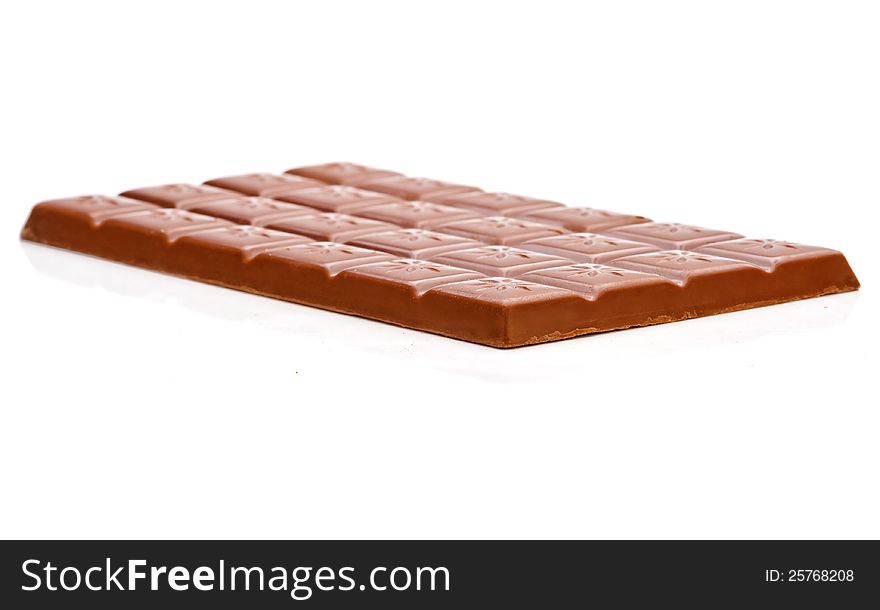 Milk chocolate bar isolated on white background. Side view.