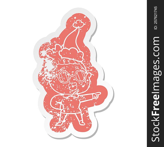 cartoon distressed sticker of a pointing woman wearing spectacles wearing santa hat