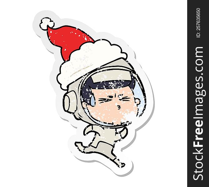 hand drawn distressed sticker cartoon of a stressed astronaut wearing santa hat