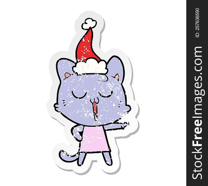 Distressed Sticker Cartoon Of A Cat Singing Wearing Santa Hat