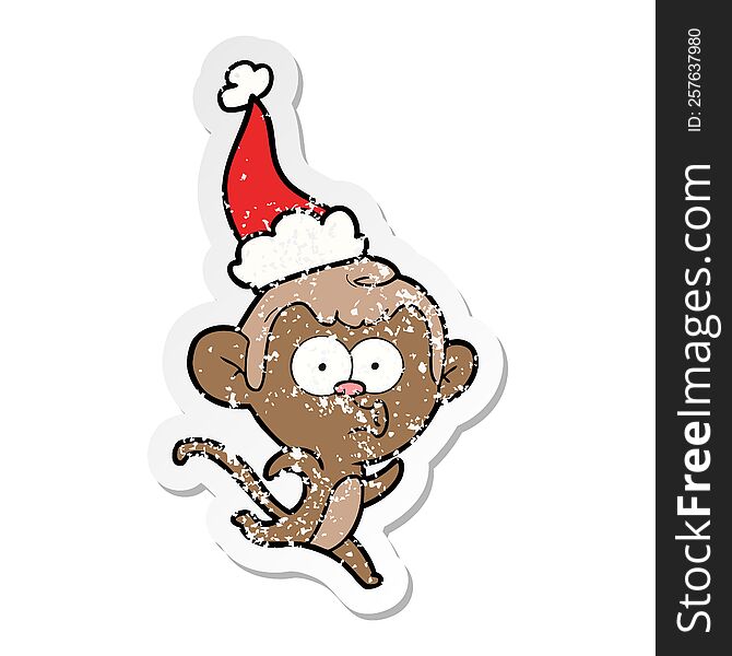 distressed sticker cartoon of a surprised monkey wearing santa hat