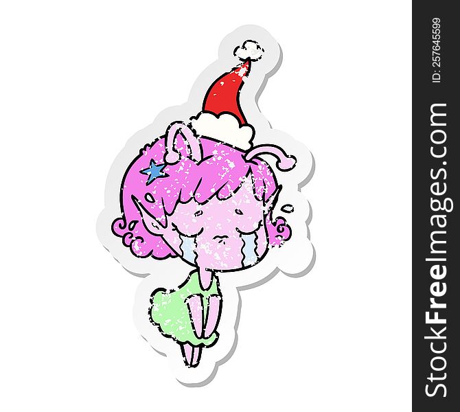 Distressed Sticker Cartoon Of A Crying Alien Girl Wearing Santa Hat