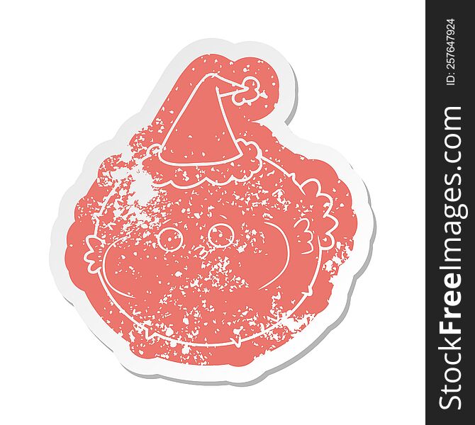 cartoon distressed sticker of a puffer fish wearing santa hat