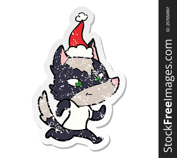 Friendly Distressed Sticker Cartoon Of A Wolf Wearing Santa Hat