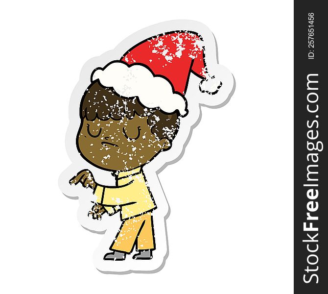 Distressed Sticker Cartoon Of A Grumpy Boy Wearing Santa Hat