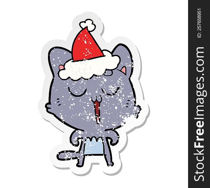 Distressed Sticker Cartoon Of A Cat Singing Wearing Santa Hat