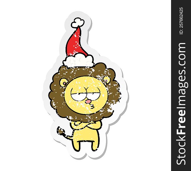 hand drawn distressed sticker cartoon of a tired lion wearing santa hat