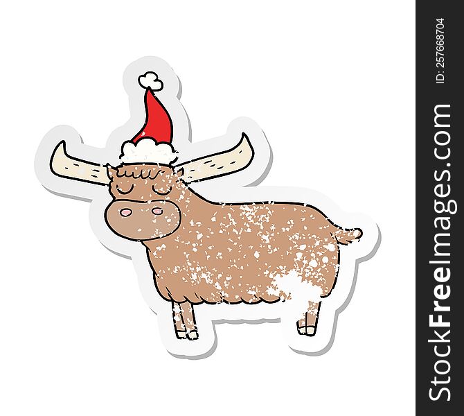 hand drawn distressed sticker cartoon of a bull wearing santa hat